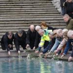 workers memorial day laying flowers at pool